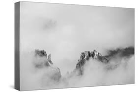 Clouds hang between the mountains of the Dolomites-Jean Schwarz-Stretched Canvas