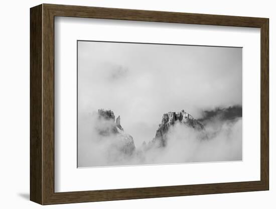 Clouds hang between the mountains of the Dolomites-Jean Schwarz-Framed Photographic Print