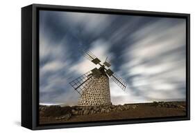 Clouds in the starry sky over a traditional windmill, La Oliva, Fuerteventura, Canary Islands-Roberto Moiola-Framed Stretched Canvas