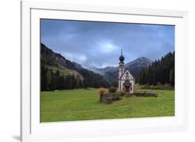 Clouds on Church of Ranui surrounded by meadows and woods in the fall, St. Magdalena, Funes Valley,-Roberto Moiola-Framed Photographic Print