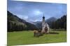 Clouds on Church of Ranui surrounded by meadows and woods in the fall, St. Magdalena, Funes Valley,-Roberto Moiola-Mounted Photographic Print