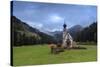 Clouds on Church of Ranui surrounded by meadows and woods in the fall, St. Magdalena, Funes Valley,-Roberto Moiola-Stretched Canvas