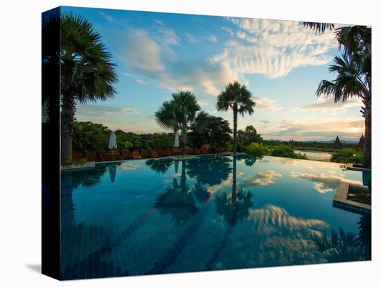 Clouds reflected in the infinity pool at sunrise, Aureum Palace Hotel, Bagan, Mandalay Region, M...-null-Stretched Canvas