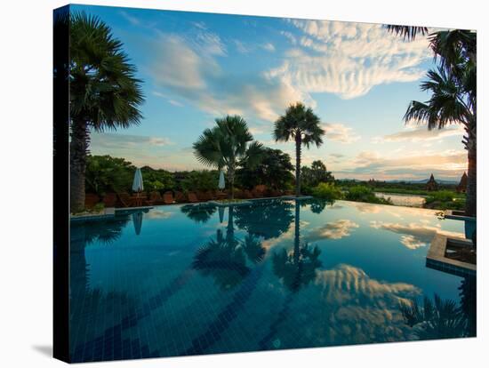 Clouds reflected in the infinity pool at sunrise, Aureum Palace Hotel, Bagan, Mandalay Region, M...-null-Stretched Canvas