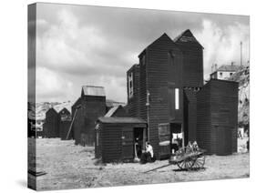 Clustered on the Shingle of the Old Town of Hastings Sussex are These Tall Black Huts-Fred Musto-Stretched Canvas