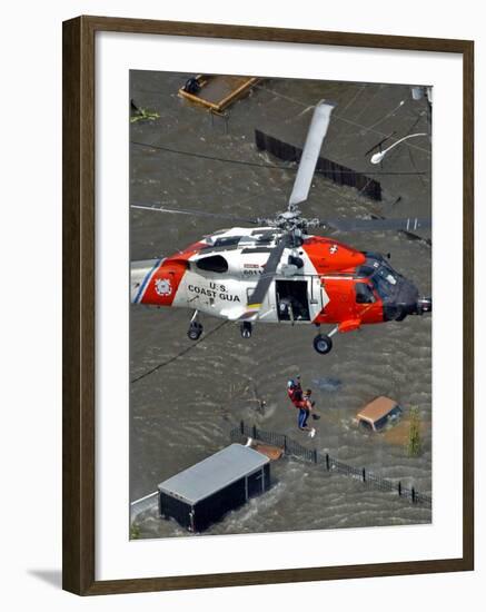 Coast Guard Rescues One from Roof Top of Home, Floodwaters from Hurricane Katrina Cover the Streets-null-Framed Photographic Print