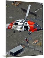 Coast Guard Rescues One from Roof Top of Home, Floodwaters from Hurricane Katrina Cover the Streets-null-Mounted Photographic Print
