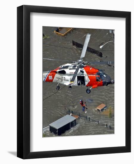 Coast Guard Rescues One from Roof Top of Home, Floodwaters from Hurricane Katrina Cover the Streets-null-Framed Photographic Print