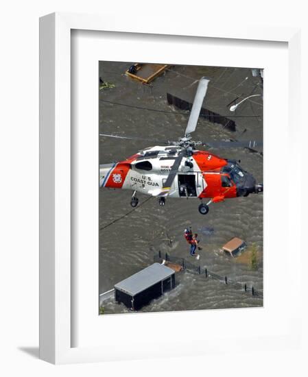 Coast Guard Rescues One from Roof Top of Home, Floodwaters from Hurricane Katrina Cover the Streets-null-Framed Photographic Print