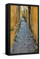 Cobblestones and yellow walls in alleyway, Hoi An, Vietnam-David Wall-Framed Stretched Canvas