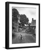 Collie Sheepdog Sitting in Road Leading Up Toward Castle Farm Owned by Beatrix Potter-George Rodger-Framed Photographic Print