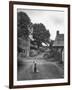 Collie Sheepdog Sitting in Road Leading Up Toward Castle Farm Owned by Beatrix Potter-George Rodger-Framed Photographic Print