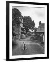 Collie Sheepdog Sitting in Road Leading Up Toward Castle Farm Owned by Beatrix Potter-George Rodger-Framed Photographic Print