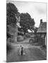 Collie Sheepdog Sitting in Road Leading Up Toward Castle Farm Owned by Beatrix Potter-George Rodger-Mounted Photographic Print