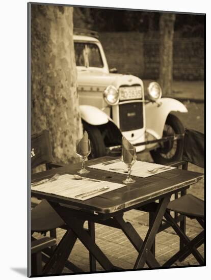 Colonia Del Sacramento, Cafe Table and Old Car, Uruguay-Walter Bibikow-Mounted Photographic Print