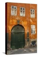 Colorful Building with Bikes Parked Outside, Copenhagen, Denmark-Inger Hogstrom-Stretched Canvas