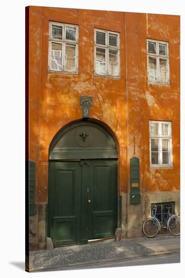 Colorful Building with Bikes Parked Outside, Copenhagen, Denmark-Inger Hogstrom-Stretched Canvas