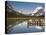 Colorful Canoes Line the Dock at Many Glacier Lodge on Swiftcurrent Lake During Sunrise-Brad Beck-Stretched Canvas