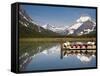 Colorful Canoes Line the Dock at Many Glacier Lodge on Swiftcurrent Lake During Sunrise-Brad Beck-Framed Stretched Canvas