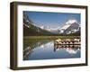 Colorful Canoes Line the Dock at Many Glacier Lodge on Swiftcurrent Lake During Sunrise-Brad Beck-Framed Photographic Print