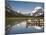 Colorful Canoes Line the Dock at Many Glacier Lodge on Swiftcurrent Lake During Sunrise-Brad Beck-Mounted Photographic Print