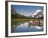 Colorful Canoes Line the Dock at Many Glacier Lodge on Swiftcurrent Lake During Sunrise-Brad Beck-Framed Photographic Print