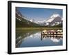 Colorful Canoes Line the Dock at Many Glacier Lodge on Swiftcurrent Lake During Sunrise-Brad Beck-Framed Photographic Print