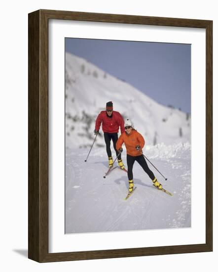 Colorful Couple Cross Country Skiing-null-Framed Photographic Print