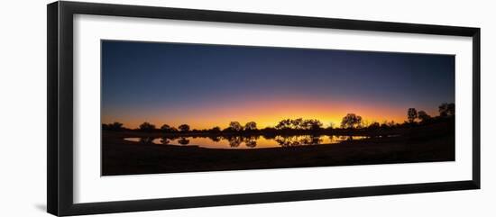 Colorful sunset at watering hole. Camelthorn Lodge. Hwange National Park. Zimbabwe.-Tom Norring-Framed Photographic Print