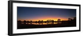 Colorful sunset at watering hole. Camelthorn Lodge. Hwange National Park. Zimbabwe.-Tom Norring-Framed Photographic Print