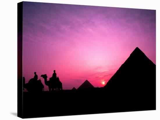 Colorful Sunset Silhouetting Men and Camels at the Great Pyramids of Giza, Egypt-Bill Bachmann-Stretched Canvas