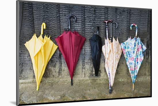 Colorful Umbrellas Leaning against a Wall-Nosnibor137-Mounted Photographic Print