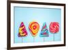 Colorful Vibrant Lollipops, Flat Lay on Blue Background-Marcin Jucha-Framed Photographic Print