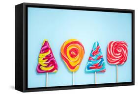 Colorful Vibrant Lollipops, Flat Lay on Blue Background-Marcin Jucha-Framed Stretched Canvas