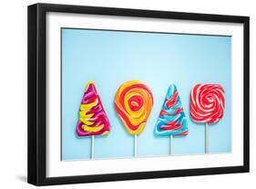 Colorful Vibrant Lollipops, Flat Lay on Blue Background-Marcin Jucha-Framed Photographic Print