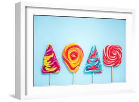 Colorful Vibrant Lollipops, Flat Lay on Blue Background-Marcin Jucha-Framed Photographic Print