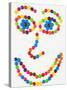 Coloured Chocolate Beans Forming a Smiling Face-Greg Elms-Stretched Canvas