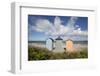 Colourful beach huts on pebble beach with blue sea and sky with clouds, Rageleje, Kattegat Coast, Z-Stuart Black-Framed Photographic Print