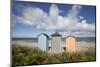 Colourful beach huts on pebble beach with blue sea and sky with clouds, Rageleje, Kattegat Coast, Z-Stuart Black-Mounted Photographic Print