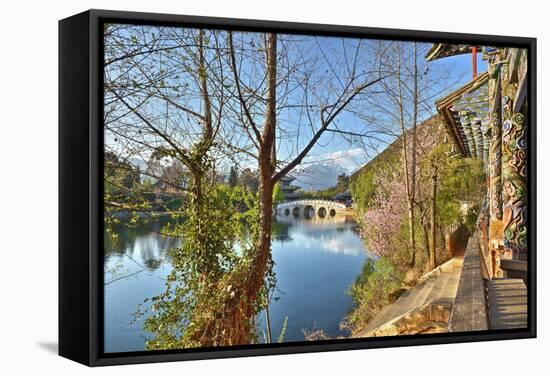 Colourful Yunnan Wood Carvings with Suocui Bridge and Moon Embracing Pavilion, Lijiang, Yunnan-Andreas Brandl-Framed Stretched Canvas