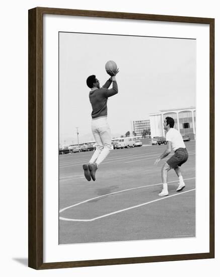 Comedian Bill Cosby Shooting Ball Against His Press Agent, Joe Sutton, During Game of Basketball-Michael Rougier-Framed Premium Photographic Print