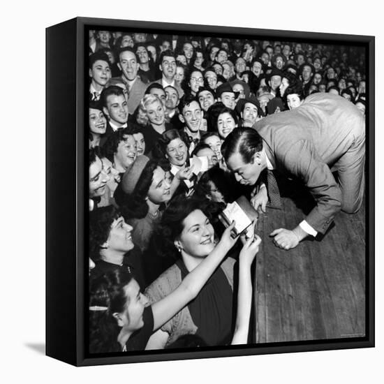 Comedian Milton Berle Trying to Kiss Fans Who Are Asking for Autographs-George Silk-Framed Stretched Canvas