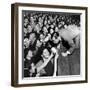 Comedian Milton Berle Trying to Kiss Fans Who Are Asking for Autographs-George Silk-Framed Premium Photographic Print