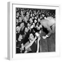 Comedian Milton Berle Trying to Kiss Fans Who Are Asking for Autographs-George Silk-Framed Premium Photographic Print