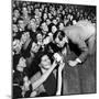 Comedian Milton Berle Trying to Kiss Fans Who Are Asking for Autographs-George Silk-Mounted Premium Photographic Print