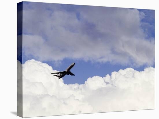 Commercial Airplane Soaring Above the Clouds-Mitch Diamond-Stretched Canvas