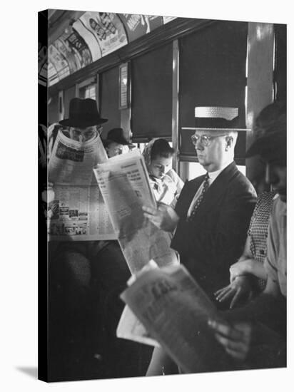 Commuters Sitting on a Train and Reading the Chicago Tribune-Charles E^ Steinheimer-Stretched Canvas