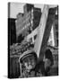 Construction Worker Carrying a Piece of Wood-Cornell Capa-Stretched Canvas