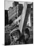 Construction Worker Carrying a Piece of Wood-Cornell Capa-Mounted Photographic Print