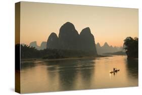 Cormorant Fisherman on Li River at Dusk, Xingping, Yangshuo, Guangxi, China-Ian Trower-Stretched Canvas